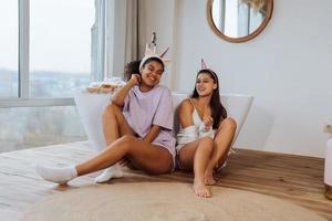 Two girls talking on the bathroom floor photo