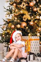 Happy little girl hugs her favorite toy in the room photo