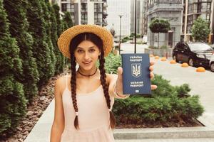 The woman shows her passport to the camera photo