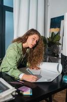 Portrait of young woman at her workplace in the home photo