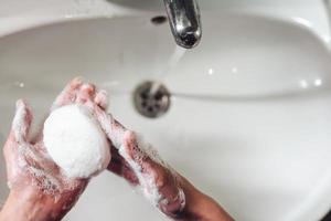 Man washing hands to protect against the coronavirus photo