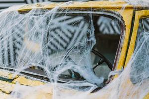 Old retro yellow taxi decorated with cobwebs photo