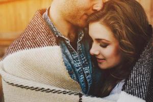 Young couple wrapped in plaid photo