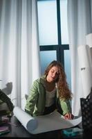 Portrait of young woman at her workplace in the home photo