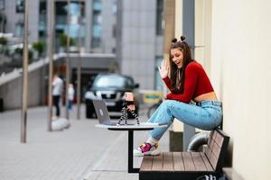 Woman blogger in a summer cafe streaming on the street. photo