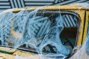 Old retro yellow taxi decorated with cobwebs photo