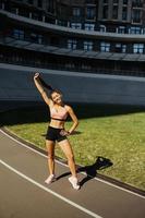 A young beautiful dark-haired athletic girl, warming up photo