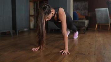 Brunette warming up and doing some push ups a the gym photo