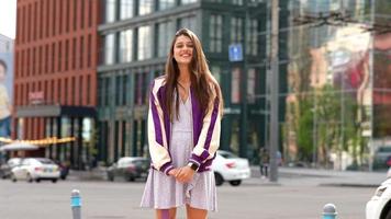 Playful portrait of pretty young woman, having fun at the street. photo