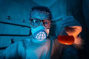 Young male researcher carrying out scientific experiment. photo