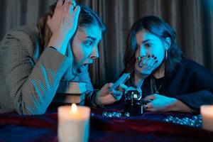 Woman and woman fortune teller with crystal ball photo