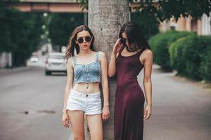 Two beautiful young girls posing in the city photo