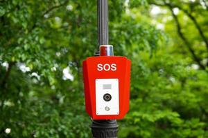 SOS, police, emergency button in the public park. photo