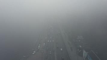 A city covered in fog. City traffic, aerial view photo