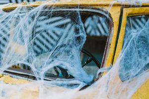 Old retro yellow taxi decorated with cobwebs photo