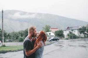 beautiful couple hugging in the rain photo