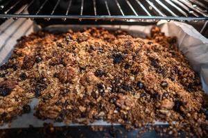 granola to cook in an electric oven. concept of simple ingredients for healthy breakfast photo