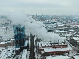 Large central boiler room with giant pipes of which there is dangerous smoke in winter during frost in a big city photo