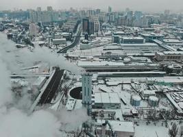 Large central boiler room with giant pipes of which there is dangerous smoke in winter during frost in a big city photo