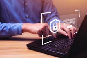 Businessman typing on keyboard laptop computer to input username and password, digital crime concept protection from hackers. cybersecurity and privacy, online scammers, secure internet access photo