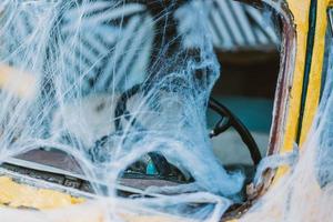 Old retro yellow taxi decorated with cobwebs photo