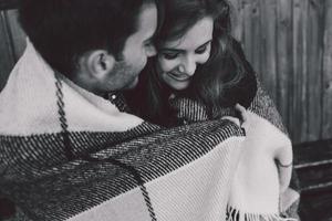 Young couple wrapped in plaid photo