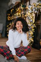 Beautiful young african american woman on the floor photo