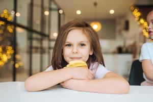 Adorable little girl looking at the camera close-up photo