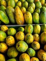 Papayas line the market - papaya fruit at the supermarket photo