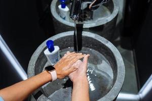 Man washing hands to protect against the coronavirus photo