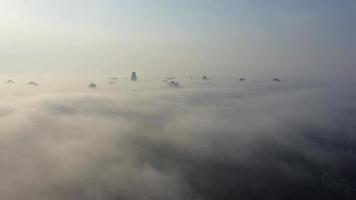 Aerial view of the city in the fog. Skyscrapers above the fog photo