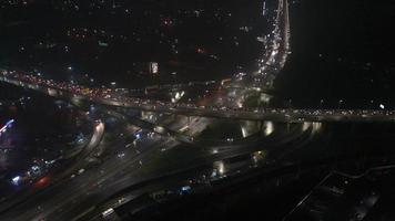 Aerial view of highway interchange at night, timelapse. photo