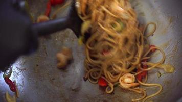 Cook stew vegetables in a pan and add spaghetti photo