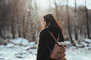 Young beautiful model posing in winter forest. stylish fashion portrait photo