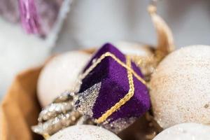 Different object toy gifts hanging from a decorated Christmas tree. photo