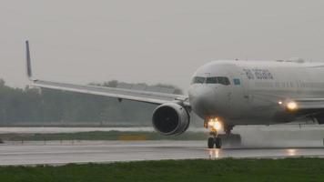 ALMATY, KAZAKHSTAN MAY 4, 2019 - Air Astana Boeing 767 P4 KEA braking after landing on runway at rainy weather. Airport of Almaty, Kazakhstan video