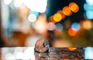 Silver bitcoin isolated on the table, glowing background photo