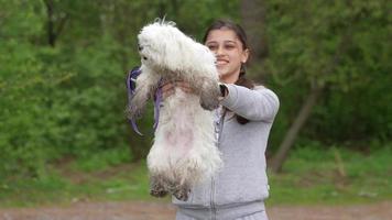 Beautiful woman holding a dog in her arms photo