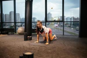 Young woman doing exercises in the gym photo