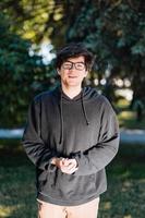 Portrait of happy young male student with glasses in casual outfit photo