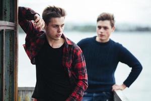 two guys stand in an abandoned building on lake photo