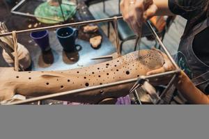 Portrait of young woman enjoying favorite job in workshop. photo