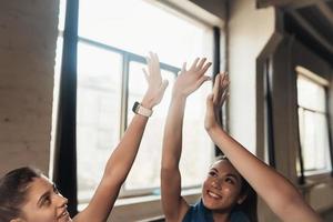 Women giving five each other after having a great workout in gym. photo