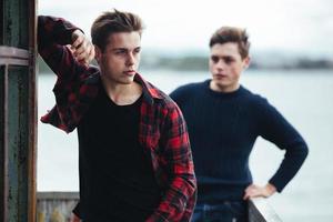 two guys stand in an abandoned building on lake photo