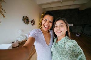 Two girls take selfies in the living room photo