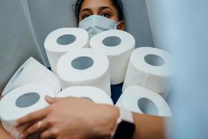 People are stocking up toilet paper for home quarantine from crownavirus. photo