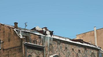 Man removing ice on the roof of buildings. photo