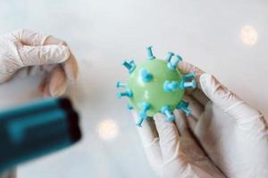 Scientist virologist holding model of new Coronavirus or COVID-19 photo