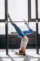 Portrait of attractive young woman doing yoga or pilates exercise photo