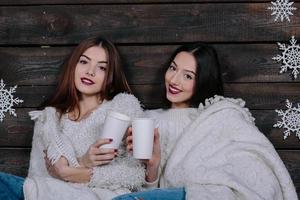 two girls drinking hot beverage photo